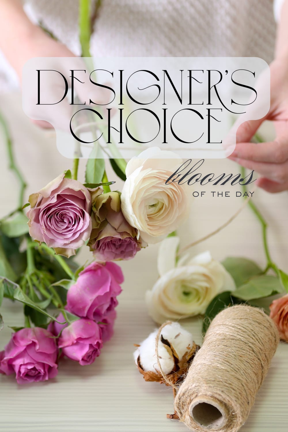 Loose pink and cream roses and ranunculus with twine and cotton labeled designer's choice blooms of the day