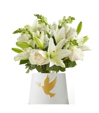 White lilies and roses in a white vase with a dove emblem