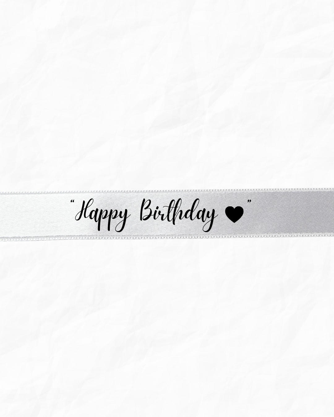 White ribbon with "Happy Birthday" text and a heart
