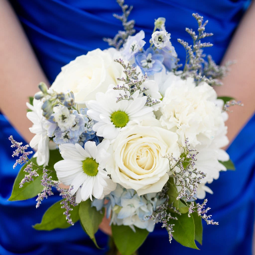 Oceanside - A serene collection of blooms in white and shades of blue create a posy bouquet that is perfect for holding in photos!  Pick up dates for prom are Saturday, April 18th, April 25th and May 2nd. Please call if you need to order this for a different event.