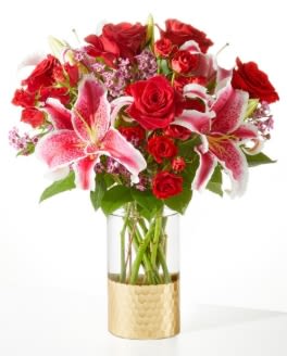 Bouquet of red roses and pink lilies in a gold vase