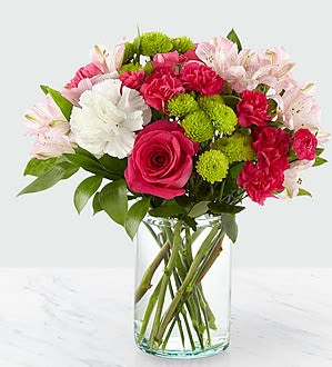 Bouquet of pink and white flowers in a clear glass vase