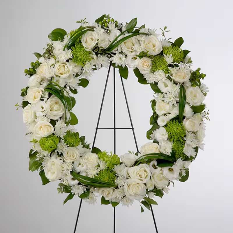 Lasting Serenity by BloomNation™  - Wooden easel. A beautiful white and green tribute wreath that calms, this easel arrangement celebrates a full life and a peaceful passing. 