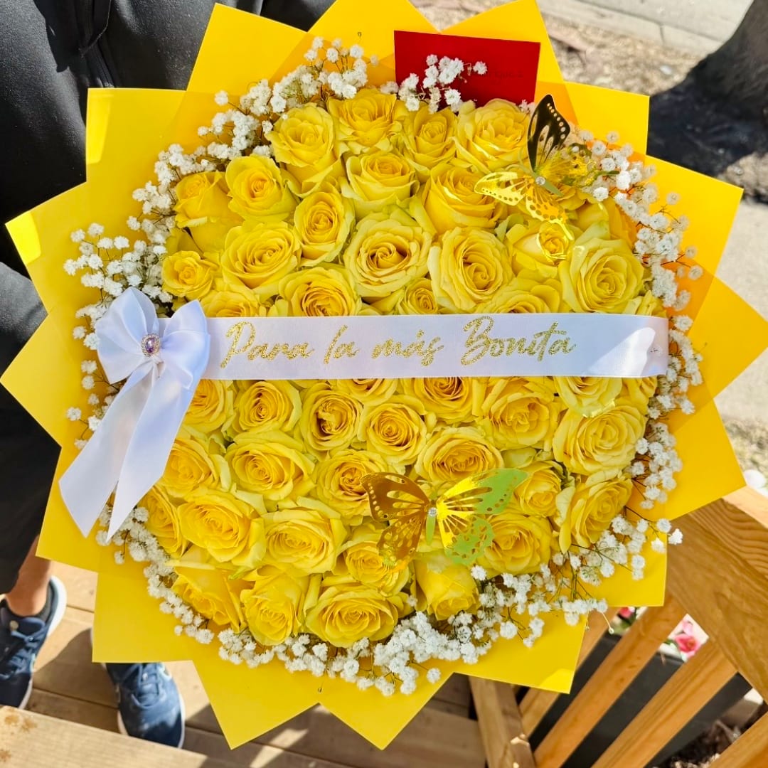 Bouquet of yellow roses with white baby's breath and a white ribbon