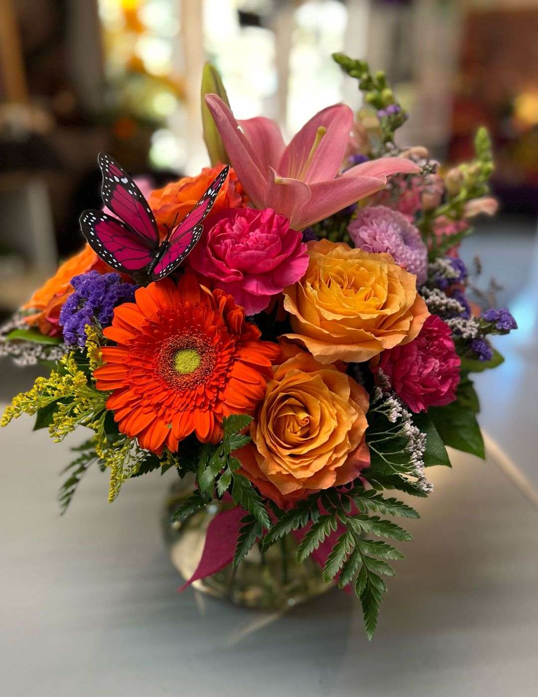 Sugar Kiss - This vibrant arrangement is sure to be a hit, with Gerberas, roses and carnations mixed with other flowers will definitely bring a smile to anyone who receives it.