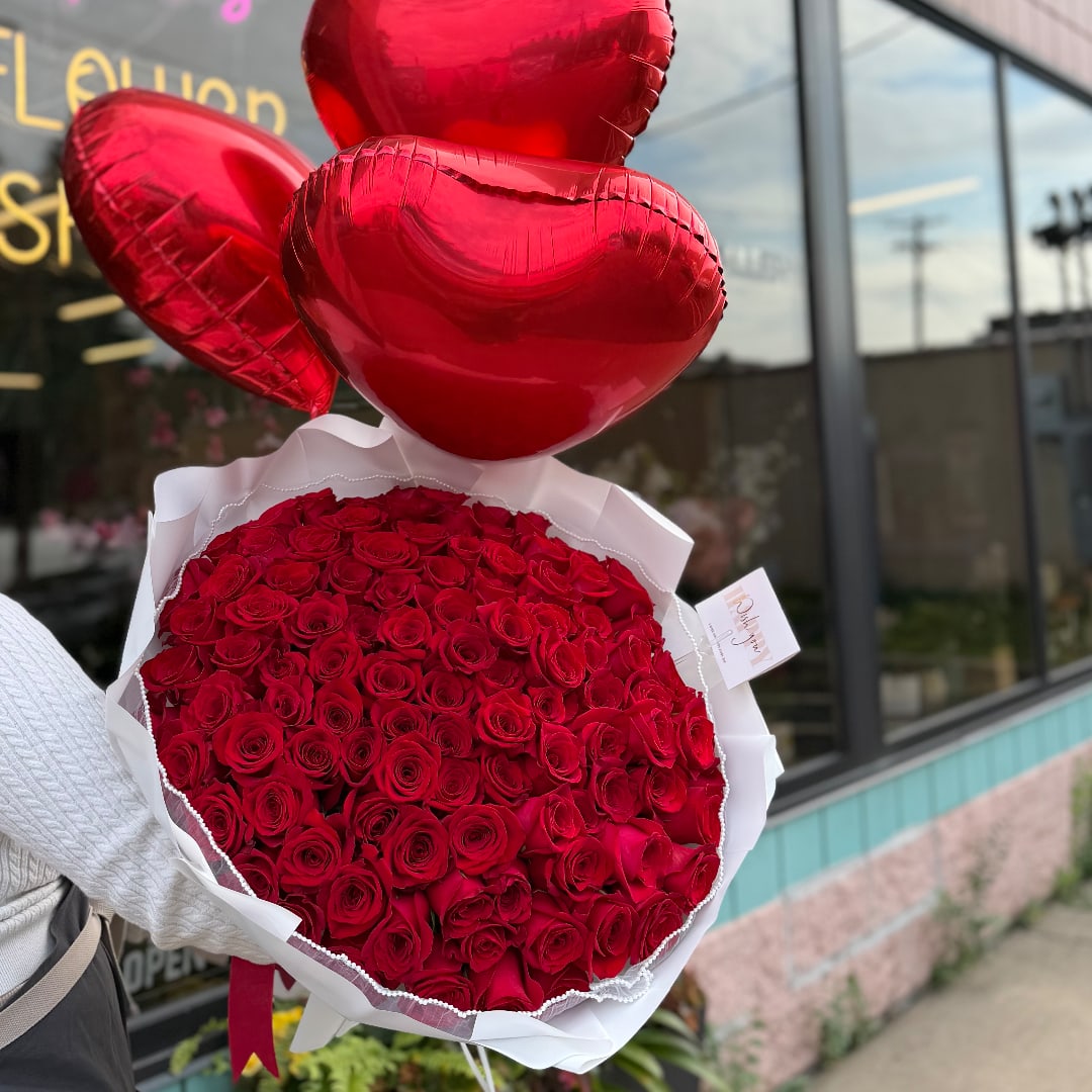Bouquet of red roses with three red heart balloons