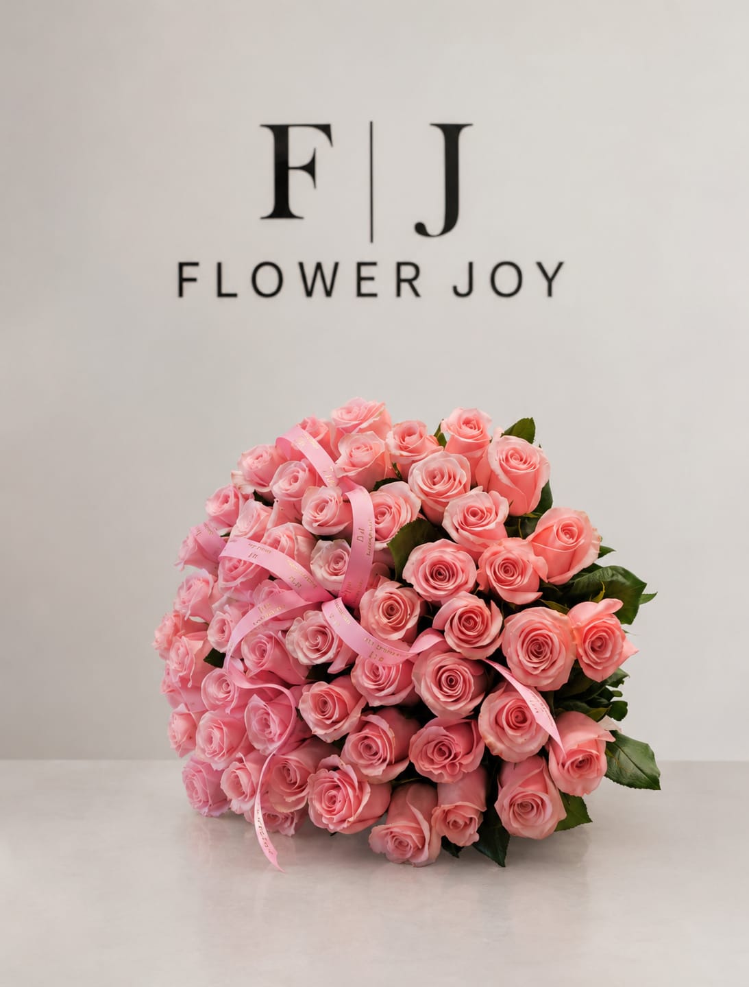 Blushing Elegance Bouquet (50 Roses) - A luxurious arrangement of soft pink roses, beautifully gathered with delicate ribbon details. Romantic, graceful, and full of charm, perfect for birthdays, anniversaries, celebrations, or simply making someone feel special. 