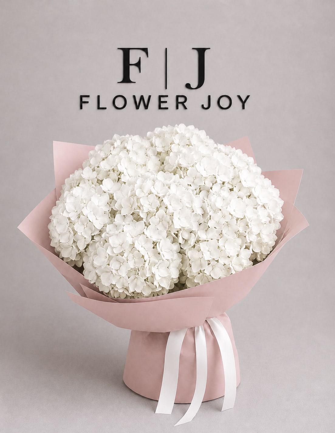 White Hydrangea Bouquet - A lush arrangement of elegant white hydrangeas, beautifully wrapped in soft blush paper and finished with delicate satin ribbons. Fresh, graceful, and timeless—perfect for birthdays, congratulations, thank-you gifts, or sophisticated celebrations.