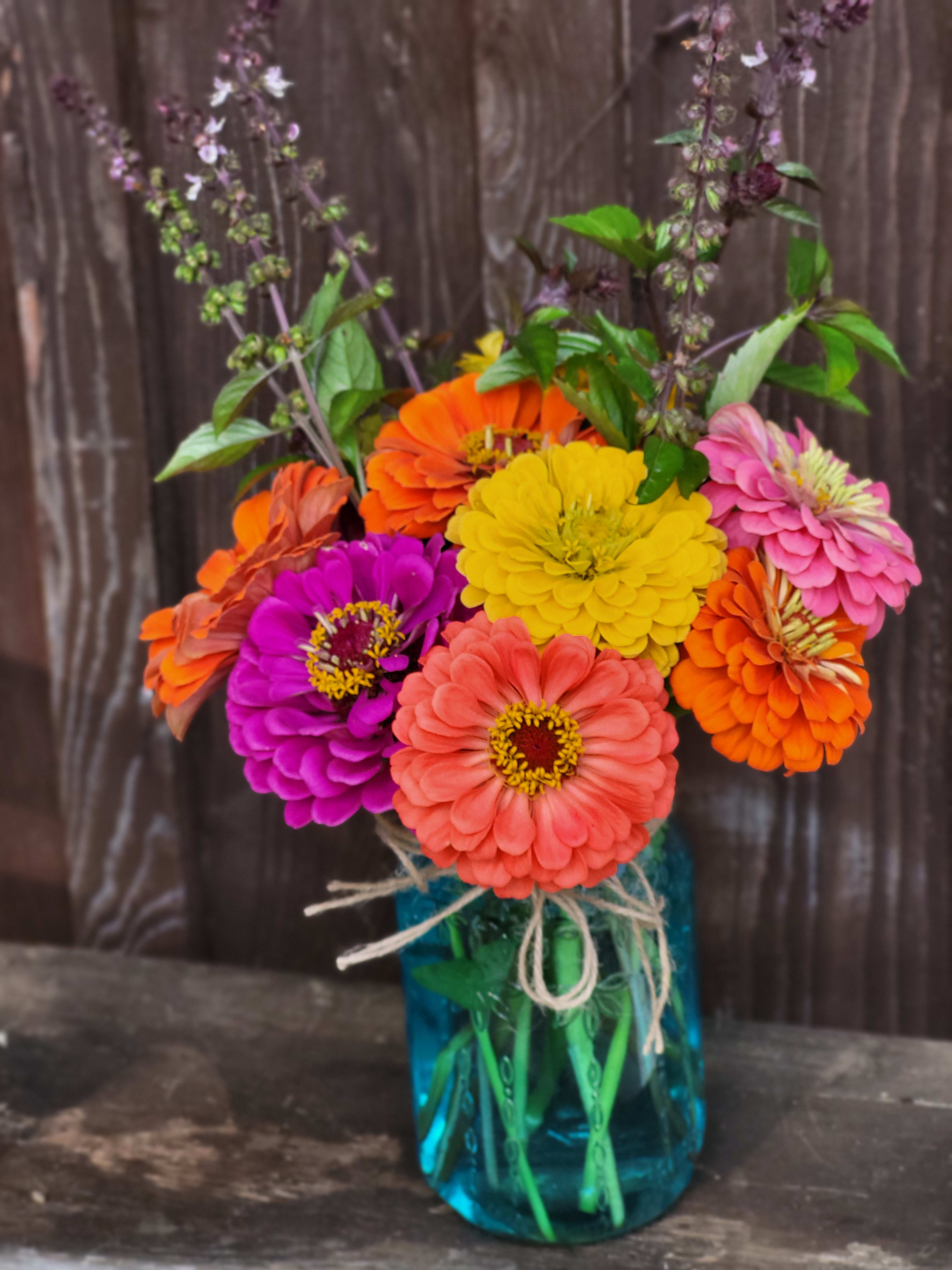 Zinnia Delight - This lovely bouquet of bright and colorful zinnias in a blue mason jar is the perfect way to celebrate summer and bring a smile to someone special.