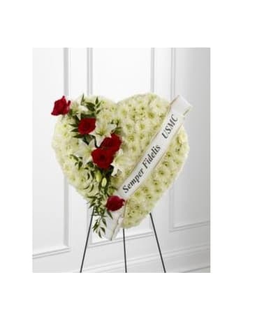 Heart-shaped white floral standing spray with red roses and a ribbon
