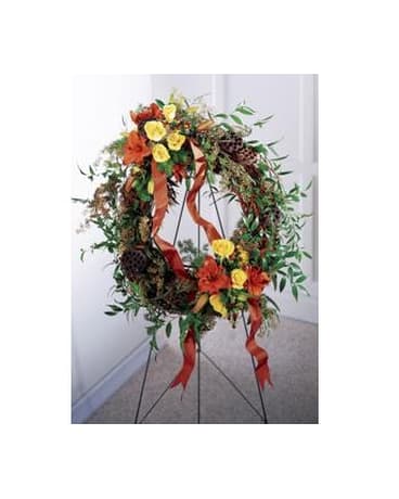 Floral wreath on a metal stand with red and yellow flowers