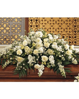Pure White Casket Spray - This casket spray with its array of white carnations larkspur asters and stock adds a pure and loving gesture to the service. One casket spray arrives decorated with white carnations larkspur lisianthus asters and stock and simple foliage. Approximately 45" W x 36" H Orientation: One-Sided   TF194-1