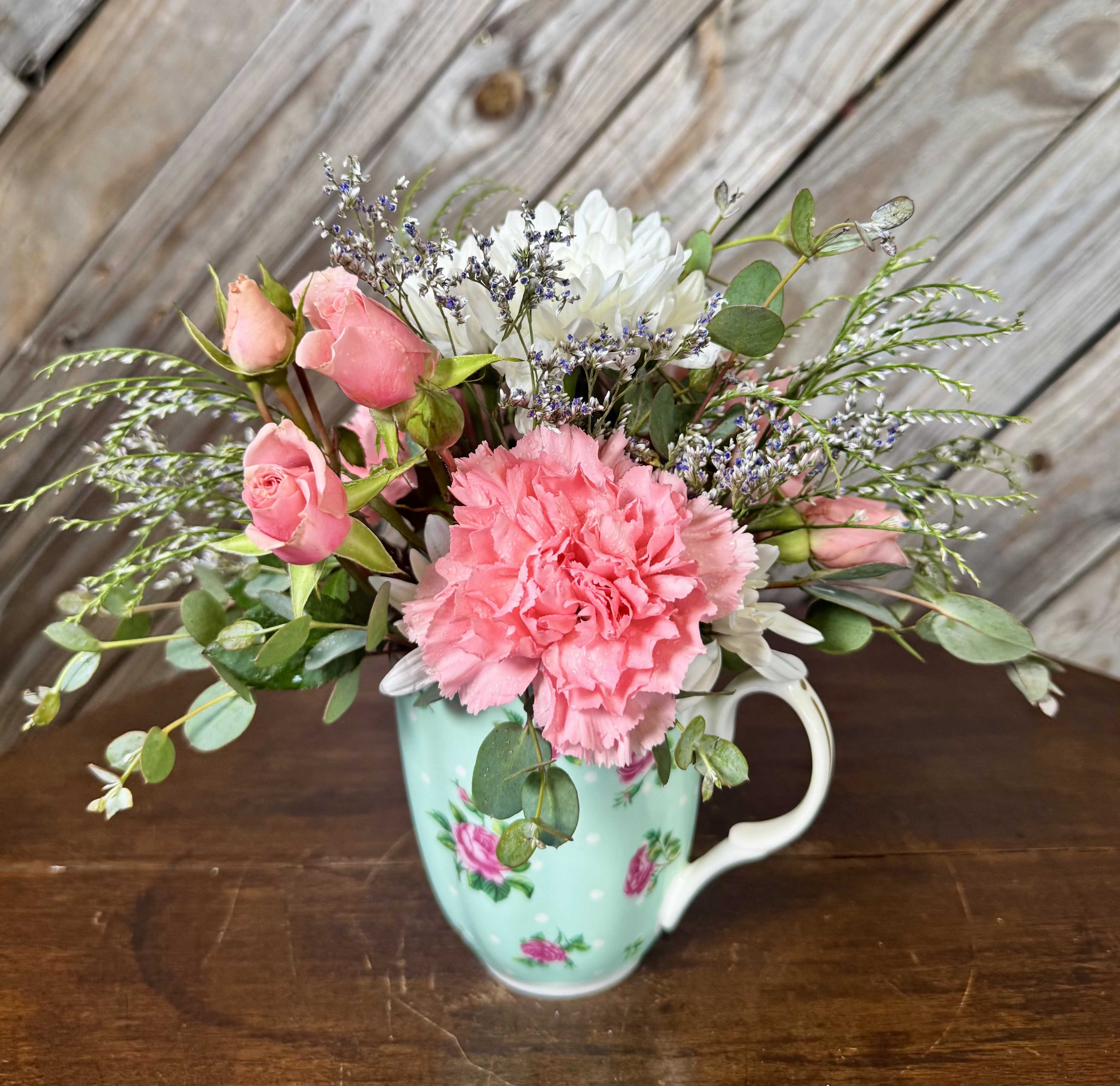  A Cup of Love for Mom - A sweet little cup filled with love  Designed in a vintage-inspired mug with soft seasonal blooms and greenery. Perfect to brighten her day or remind her she’s loved—long after. Each is unique; tea cup and flowers may vary.
