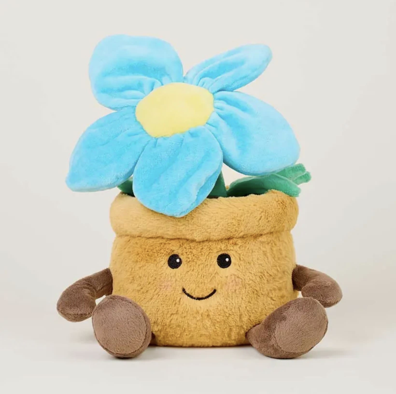 Warmies Blue Flower Pot - Warmies® Blue Flower Pot – Microwavable Plush with Lavender Scent  Brighten their day with the Warmies Blue Flower Pot—an adorable plush flower that combines cozy comfort with cheerful charm. Filled with natural flaxseed and calming French lavender, this microwavable plush offers gentle warmth and a light, relaxing scent.  Perfect for spring gifts, get-well wishes, or anyone who loves flowers that never wilt! Pair it with a real bouquet or plant from The Blooming Bud for a sweet and comforting surprise that blooms year-round.