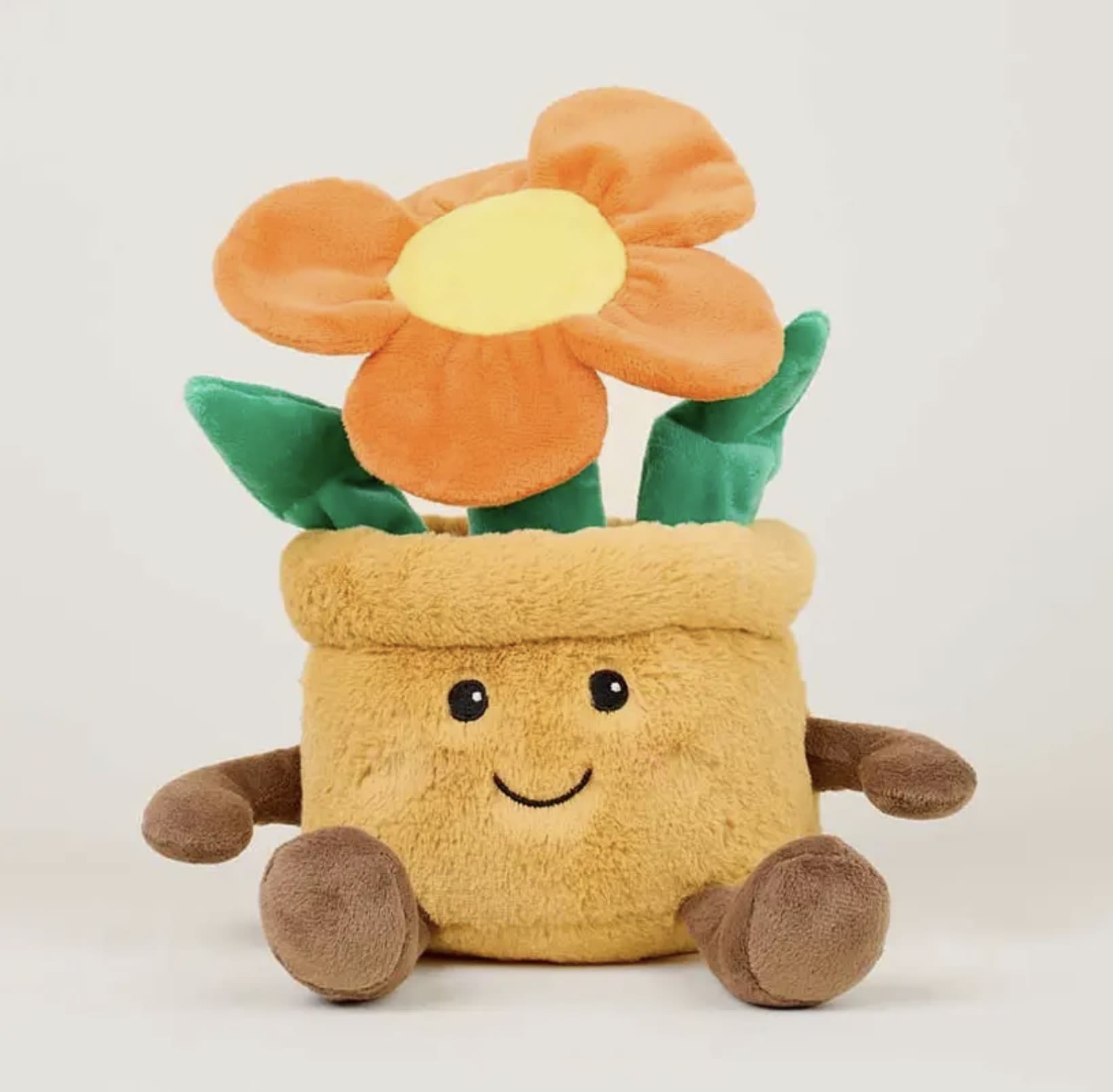 Orange Flower Pot Warmies - Warmies® Orange Flower Pot – Microwavable Plush with Lavender Scent  Brighten their day with the Warmies Yellow Orange Pot—an adorable plush flower that combines cozy comfort with cheerful charm. Filled with natural flaxseed and calming French lavender, this microwavable plush offers gentle warmth and a light, relaxing scent.  Perfect for spring gifts, get-well wishes, or anyone who loves flowers that never wilt! Pair it with a real bouquet or plant from The Blooming Bud for a sweet and comforting surprise that blooms year-round.