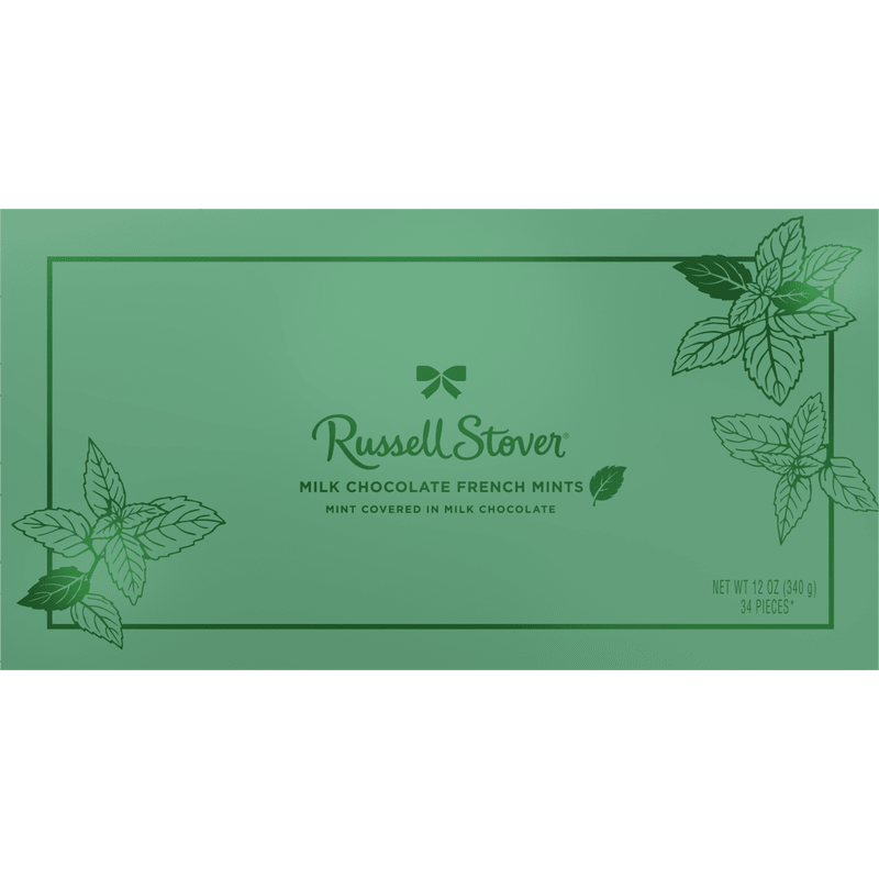 Milk Chocolate French Mints - A refreshing, gift-ready pairing centered on classic mint-chocolate indulgence that feels perfect for holiday gifting or a thoughtful thank-you. This flower arrangement pairs cool green and white tones with a boxed candy accent-the rectangular Russell Stover milk chocolate French mints in a pale green wrapper-so the person you're thinking of sees both beauty and a sweet treat. It reads as a fresh, seasonal present that works well for holiday visits, hostess gifts, or sending warm wishes.  The arrangement features a crisp green-and-white color story complemented by the mint candy box as a tasteful hard-good accent; leaf-like textures and clean lines echo the wrapper's botanical motif for a cohesive look. Sized to brighten a tabletop or entryway, it arrives ready to display and share-no fussing needed. Ideal for someone who enjoys classic sweets and subtle seasonal styling, it makes receiving feel both festive and personal.