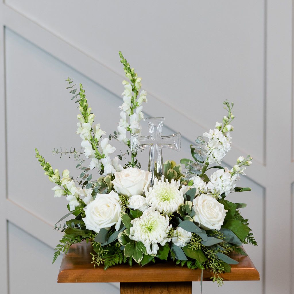 Divine - Simply elegant.  A crystal cross surrounded by white blooms is a reminder of caring thoughts.  Approximately: 16" High x 16" Wide