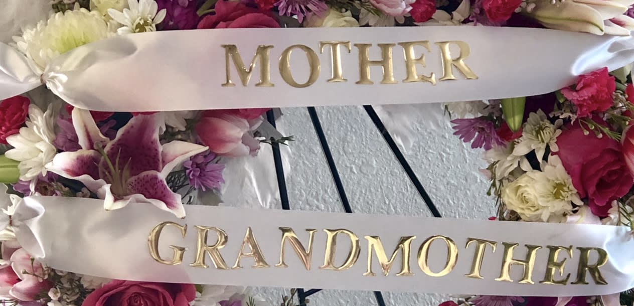 Floral wreath with satin ribbons reading Mother and Grandmother