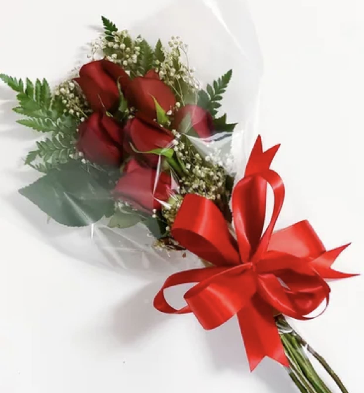 Bouquet of red roses wrapped in clear plastic with a red ribbon bow