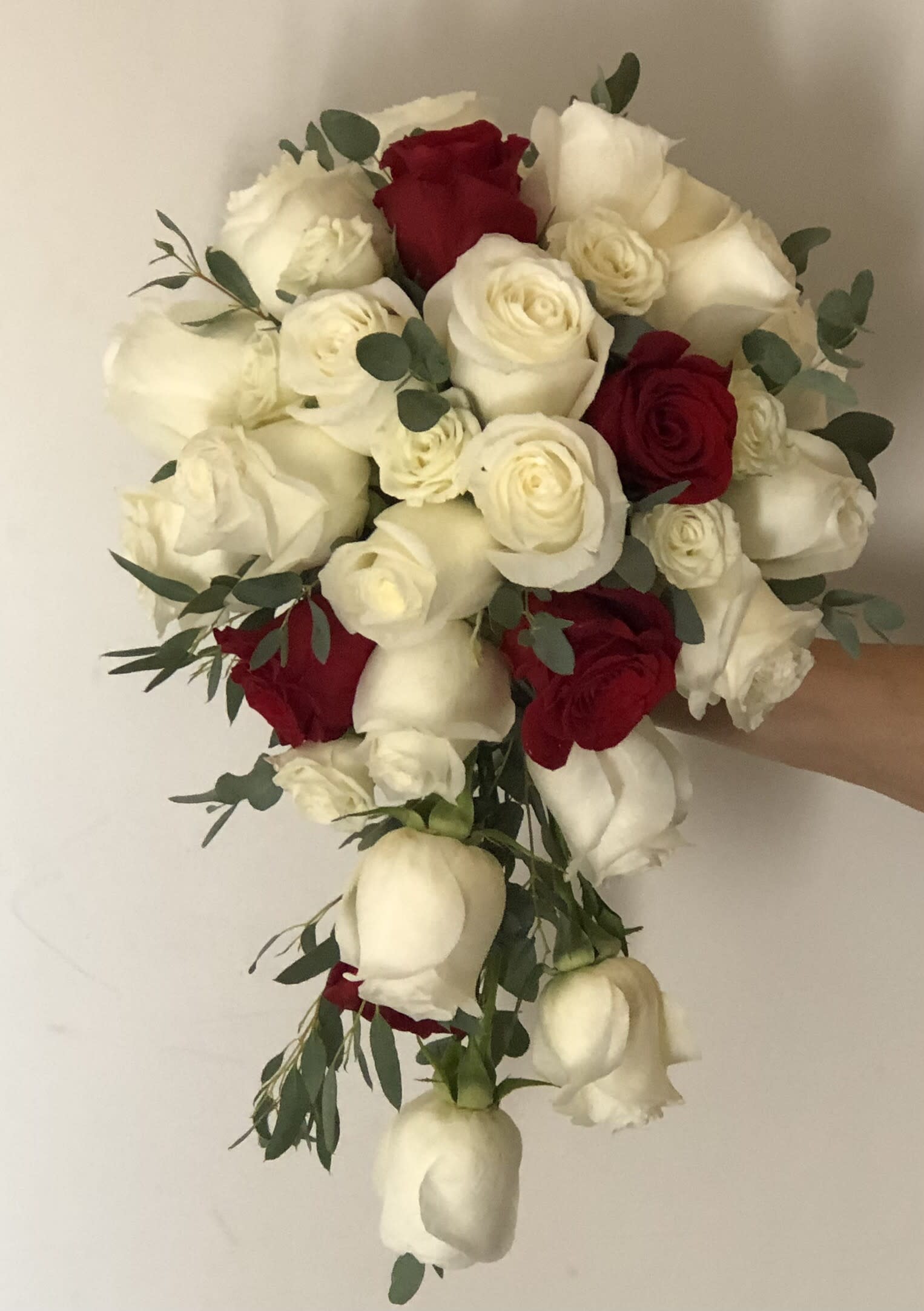 Bouquet of red and white roses with eucalyptus greenery