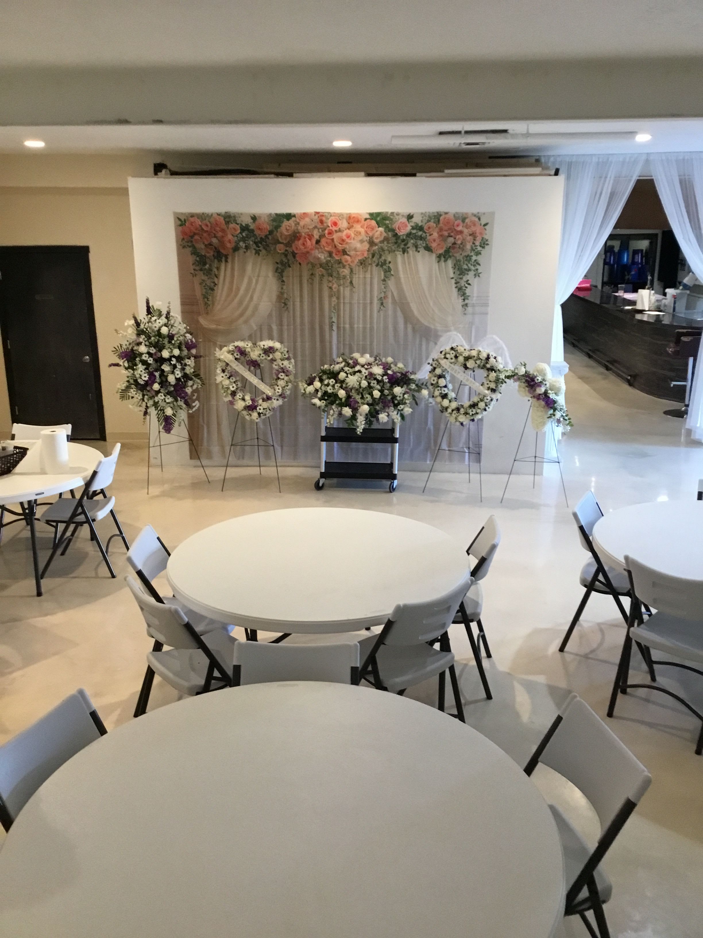 Wedding floral display with pink and white arrangements on stands