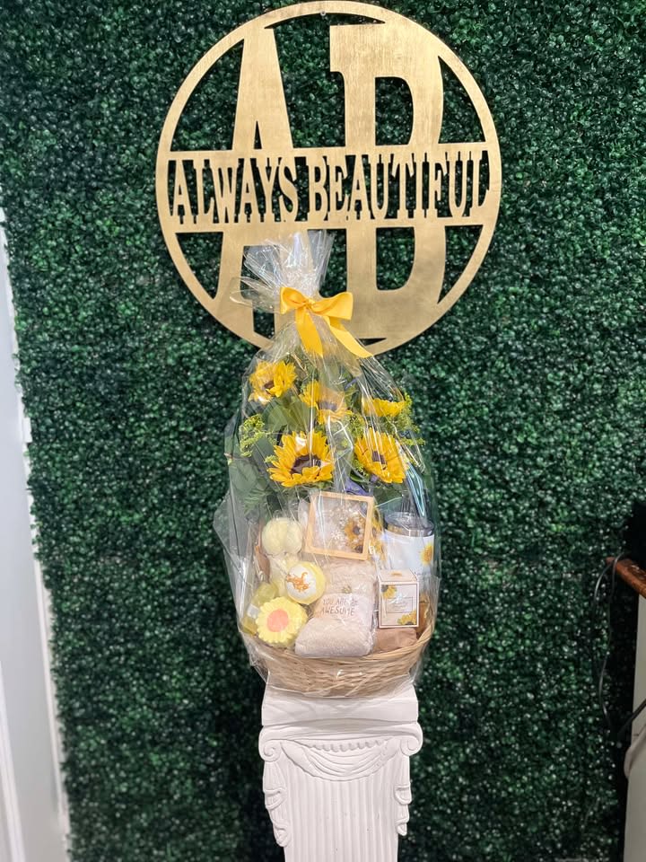 Gift basket with sunflowers and assorted items wrapped in clear cellophane