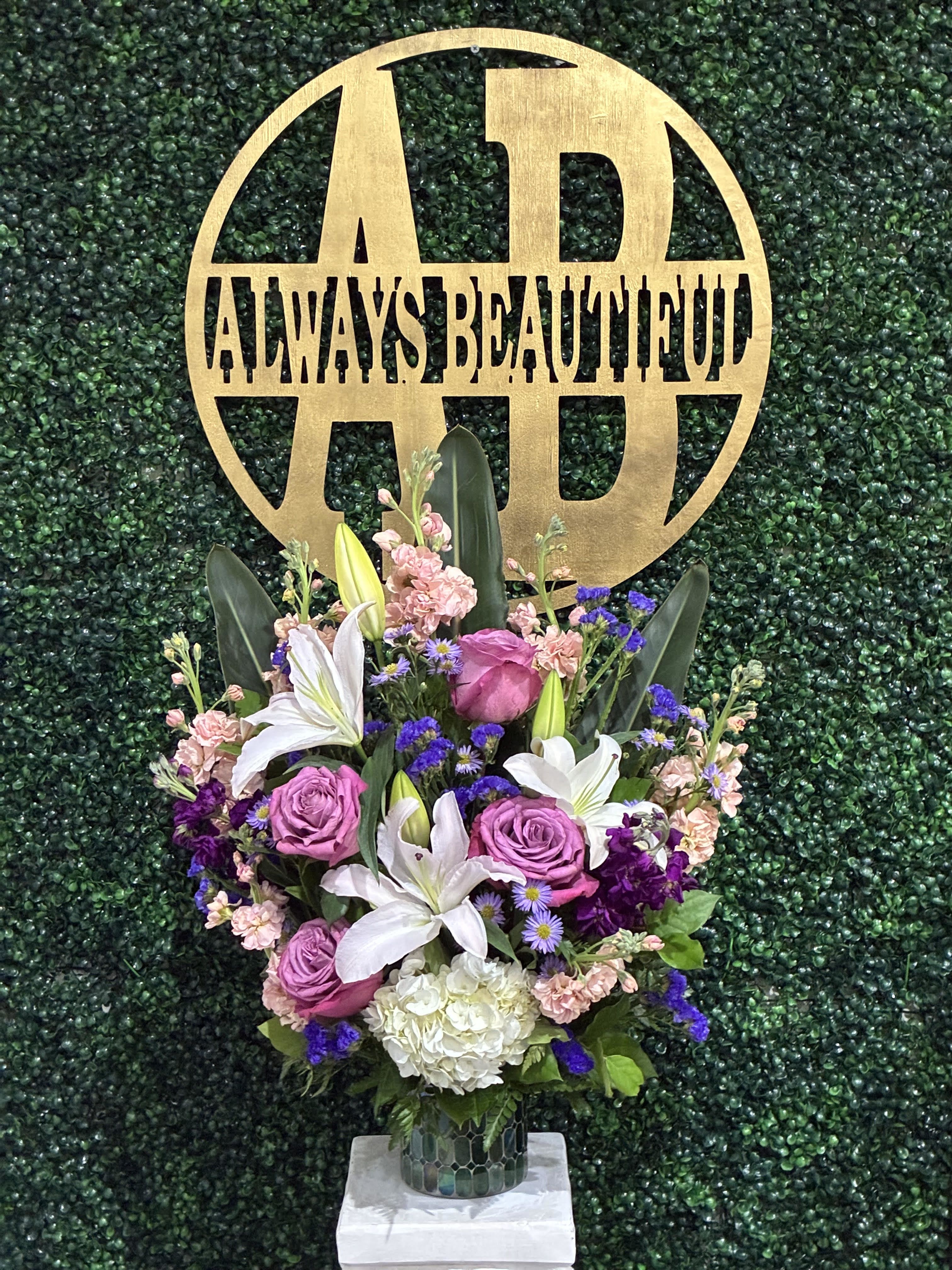 Purple Blessing - A purple and white sympathy basket featuring snapdragons, roses, lilies, and stock. This fragrant arrangement works for every type of funeral ceremony.