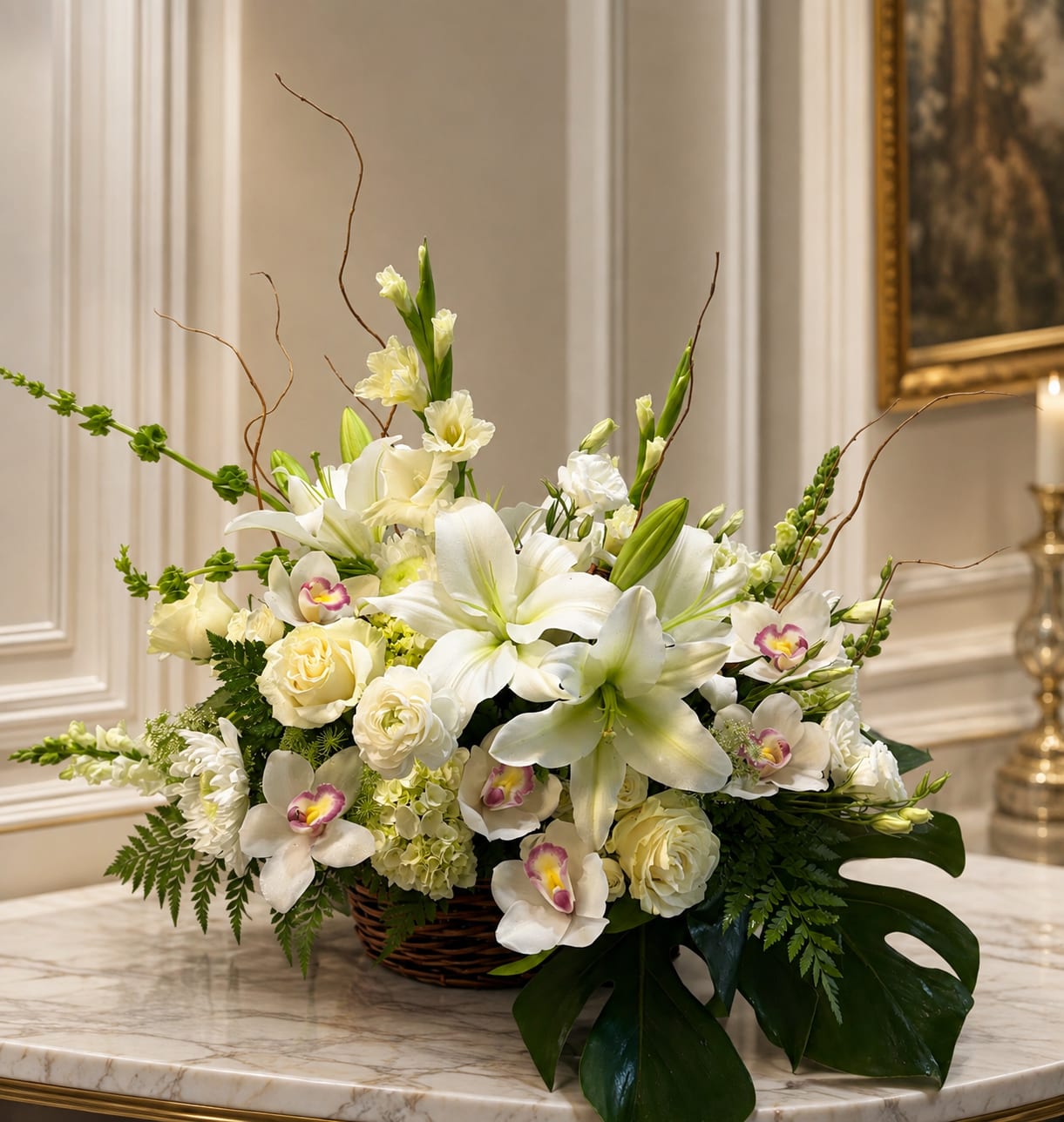 White floral arrangement in a wicker basket with lilies and orchids