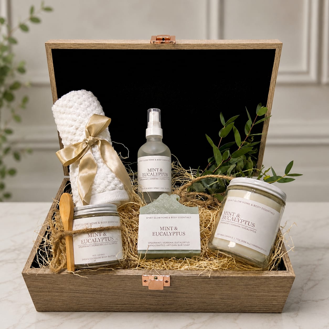 Gift box with mint eucalyptus bath items, a towel, and a candle