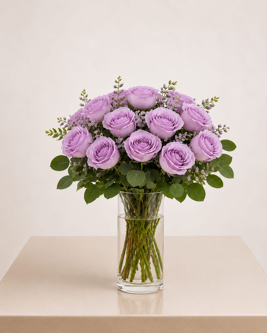 Lavender roses arranged in a clear glass vase