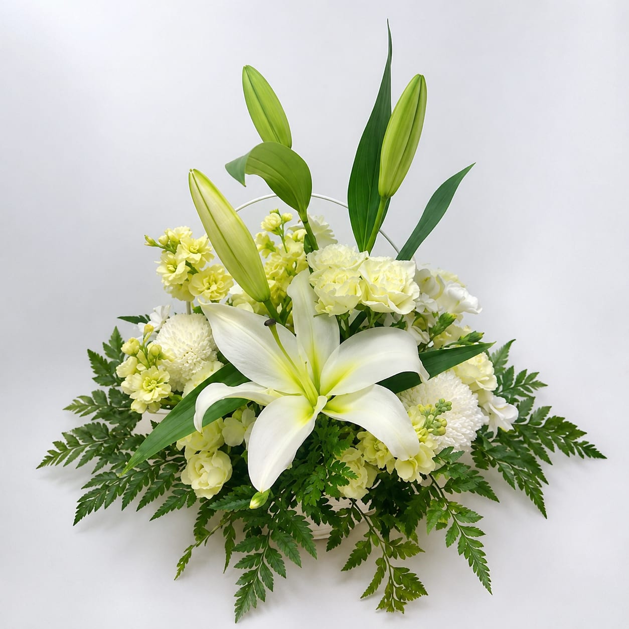 Remembrance - Graceful and calming, Serenity Blooms features white lilies, roses, and seasonal blooms accented with lush greenery. This all-white arrangement is designed to bring comfort, elegance, and quiet beauty to any space or sentiment.  Perfect  for: Sympathy, Get Well Soon, Mother’s Day, Thank You, New Baby, Thinking of You.  Available for local flower delivery throughout Naples, Bonita Springs, Estero, Fort Myers and Fort Myers Beach.  Designer’s Choice: Each arrangement is uniquely designed using the freshest seasonal flowers available. Flower varieties, colors and containers may vary while maintaining the overall style, value and beauty of the design. 