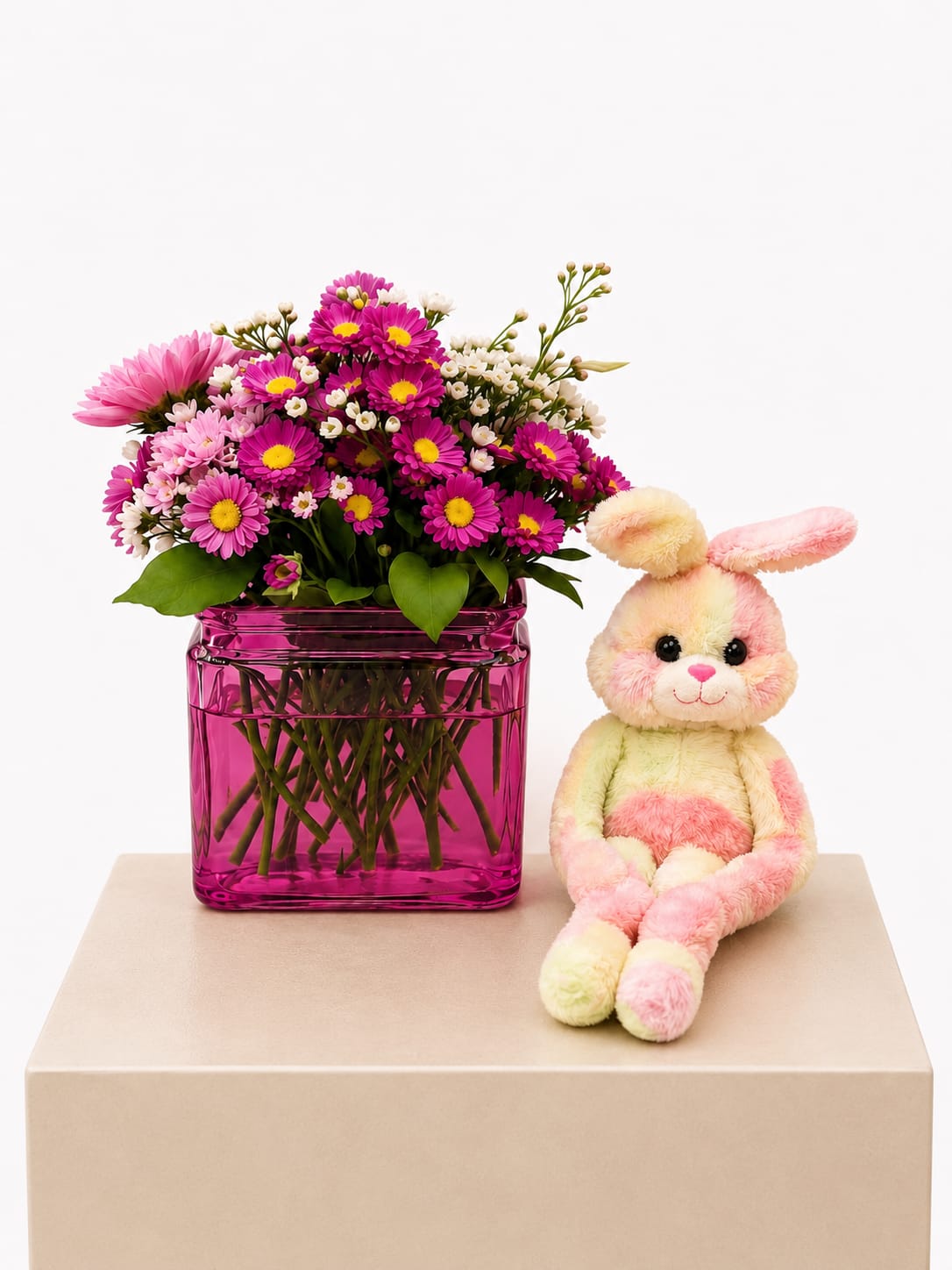Springtime Surprise | Designer Choice - A charming floral arrangement in a stylish ceramic vase, paired with an adorable plush bunny. A perfect gift to celebrate spring, Easter, or simply brighten someone’s day!  Perfect for: Easter, spring celebrations, baby showers, or as a sweet surprise!  Available for local flower delivery throughout Naples, Bonita Springs, Estero, Fort Myers and Fort Myers Beach.  Designer’s Choice: Each arrangement is uniquely designed using the freshest seasonal flowers available. Flower varieties, colors and containers may vary while maintaining the overall style, value and beauty of the design.