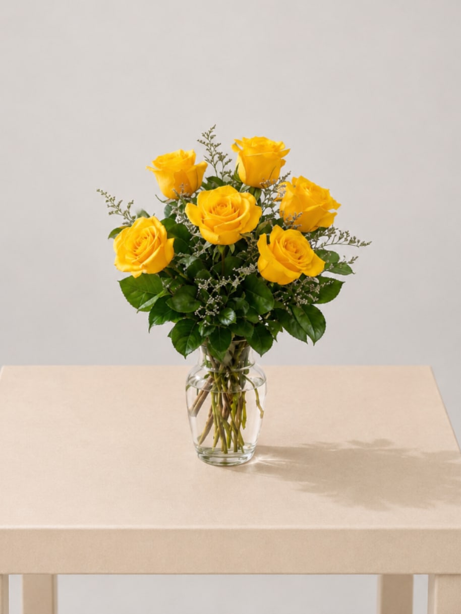 Yellow Rose Delight - A charming vase filled with  six fresh yellow roses, designed with soft greenery for a bright and uplifting look. Elegant, timeless, and full of warmth.  Perfect for: Mother’s Day, Women’s Day, Valentine’s Day, Anniversary, Love &amp; Romance, Birthday, Thinking of You, Just Because.  Available for local flower delivery throughout Naples, Bonita Springs, Estero, Fort Myers and Fort Myers Beach.  Designer’s Choice: Each arrangement is uniquely designed using the freshest seasonal flowers available. Flower varieties, colors and containers may vary while maintaining the overall style, value and beauty of the design.