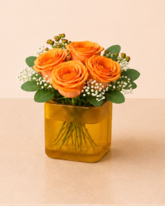 Designer’s Choice Square Rose Vase - A charming flower arrangement featuring four premium roses, accented with delicate filler blooms and fresh greenery. Thoughtfully designed in a modern square glass vase that showcases the natural beauty of the stems, this design is simple, elegant, and perfect for everyday gifting.  Perfect for Mother’s Day, birthdays, thank you gestures, expressions of love, thinking of you, friendship, or a sweet and thoughtful everyday surprise.  Available for local flower delivery throughout Naples, Bonita Springs, Estero, Fort Myers and Fort Myers Beach.  Designer’s Choice: Each arrangement is uniquely designed using the freshest seasonal flowers available. Flower varieties, colors and containers may vary while maintaining the overall style, value and beauty of the design.