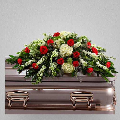 Sincerity Farewell - This casket presents the fresh color and beauty. It's a lovely arrangement to comfort people grieving the loss of the depart.   Ingredients: Rich red roses and carnations, white hydrangea, larkspur, snapdragons, Queen Anne's Lace and assorted lush greens Vase: Presented on a wire easel Size: Standard, Approximately 30"h*48"w Deluxe, Approximately 30"h*48"w Premium, Approximately 30"h*48"w