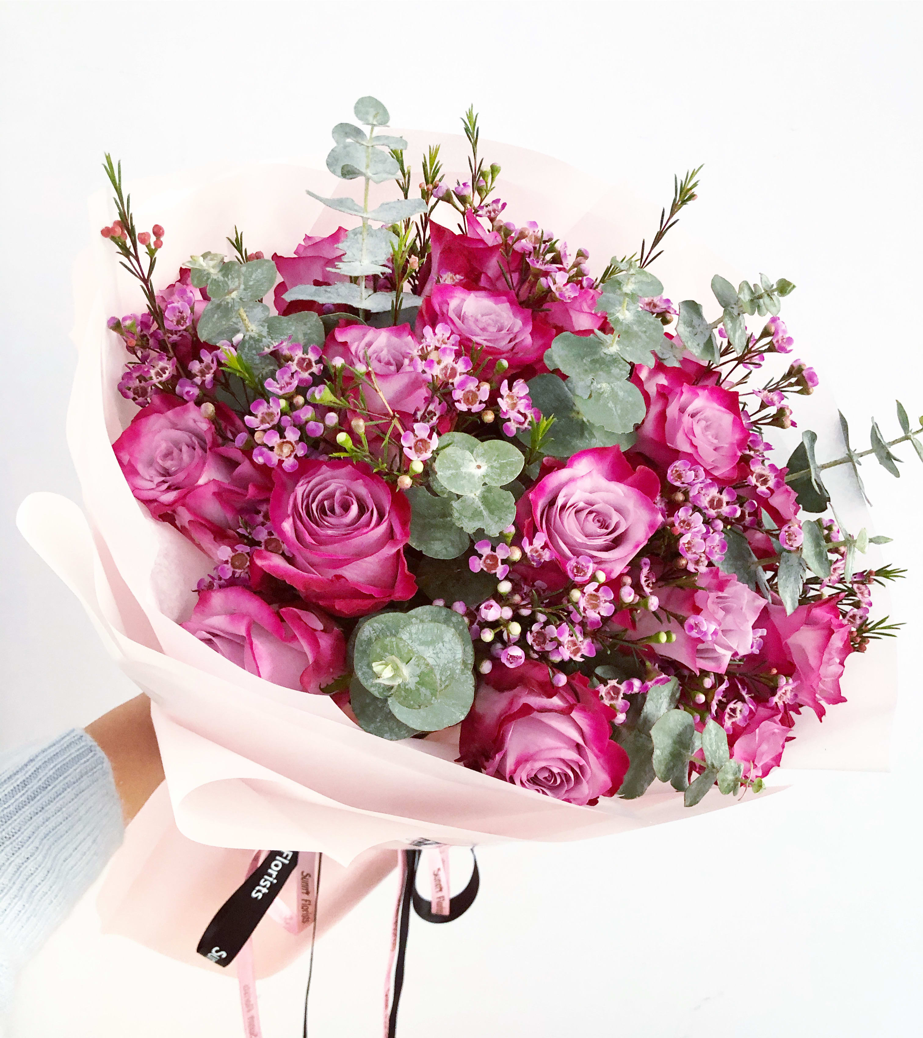 Lavender Opulence - This arrangement features premium deep purple roses, accented with scented wax flowers or appropriated fillers and greens.  