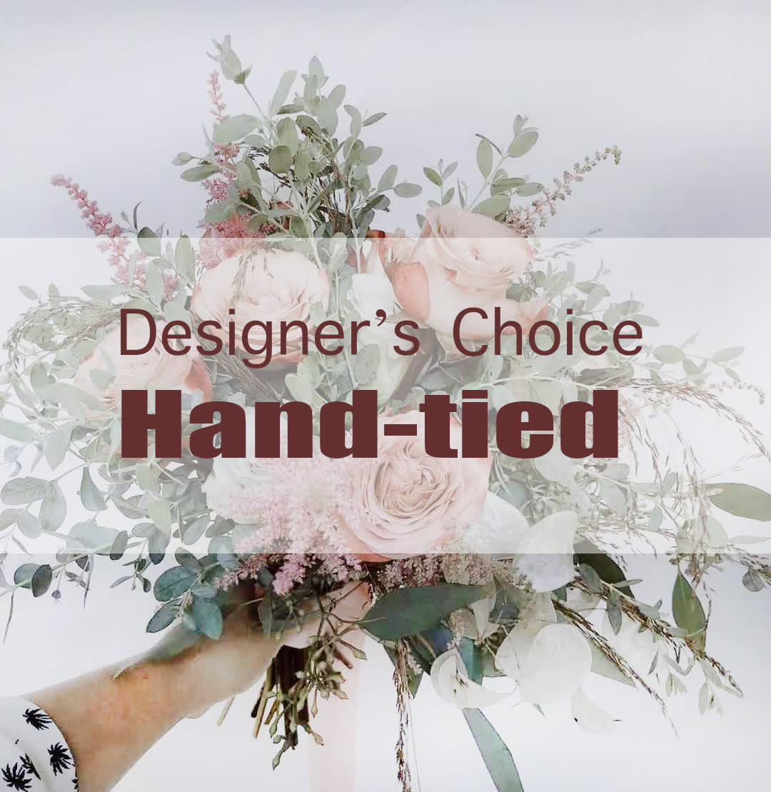 Hand-tied bouquet of pale pink roses and airy greenery