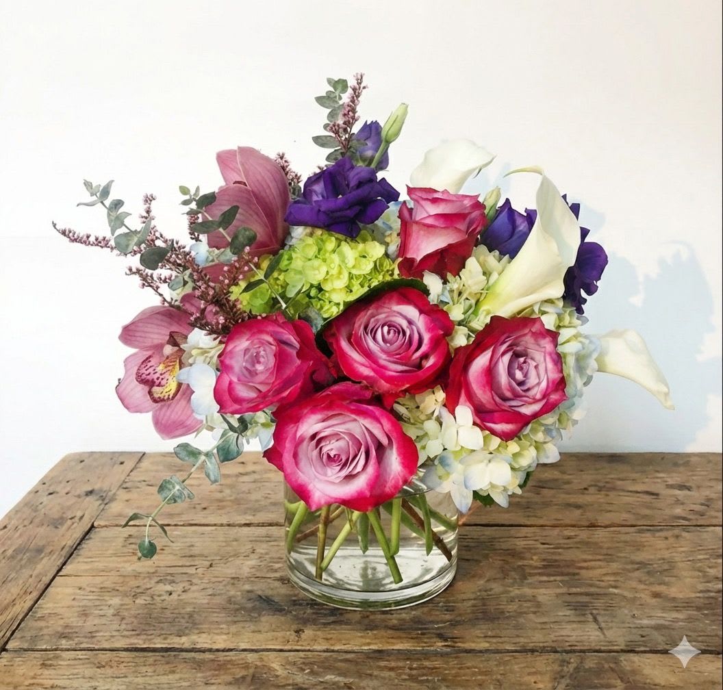 Pink roses and white calla lilies in a glass vase