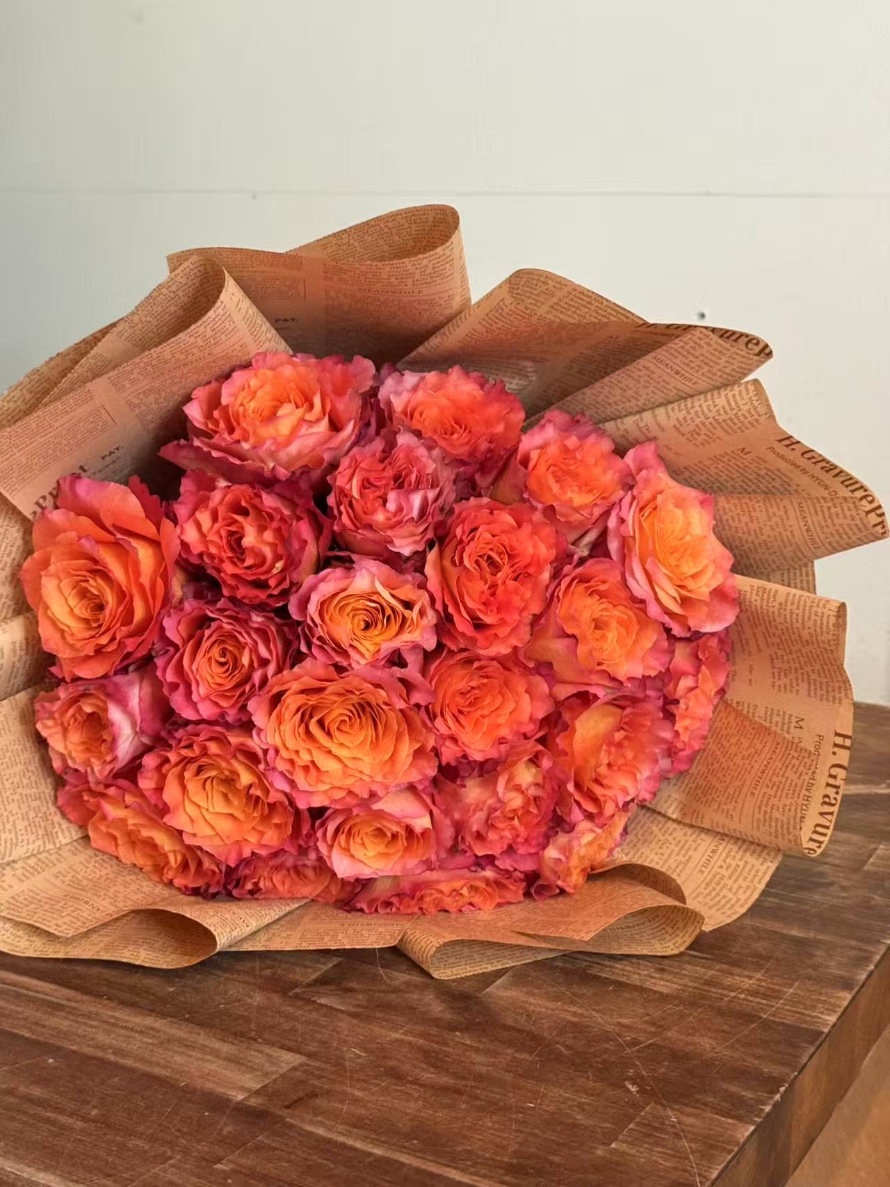 Sunset Rose Bouquet - Say hello to Sunset — a vibrant burst of happiness wrapped up in roses! This stunning bouquet features premium free spirt garden roses in glowing shades of coral, orange, inspired by the most beautiful summer sunsets over Boston.  Full of warmth and joyful color, Sunset is perfect for birthdays, congratulations, anniversaries, or just because. Hand-wrapped in our signature rustic style, it’s a fresh and cheerful gift that instantly brightens any day.  Perfect for:  Celebrations  Romantic surprises  Sending love and good vibes  Let Sunset bring a little golden-hour magic to someone special.
