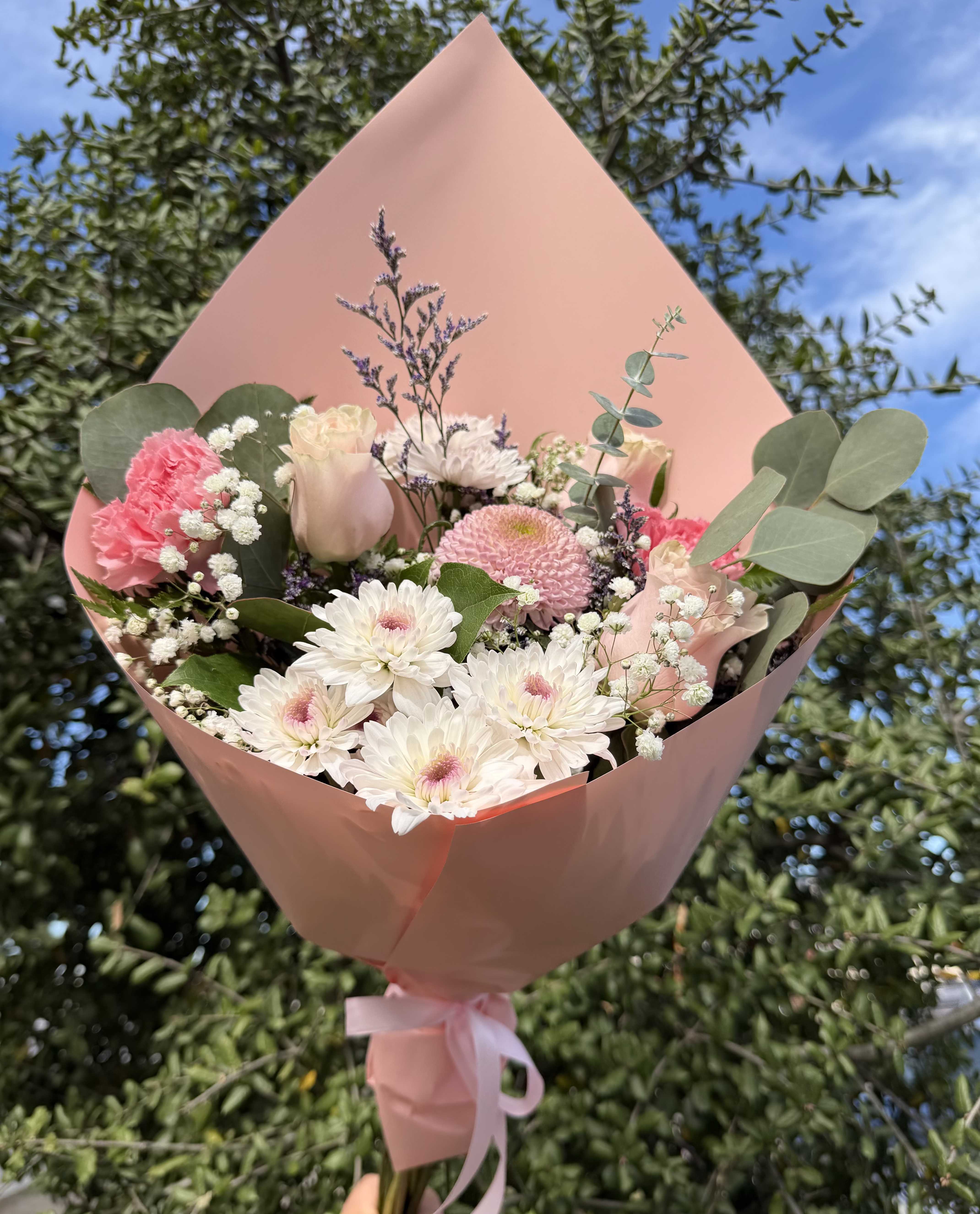 Pink and white mixed bouquet wrapped in pink paper