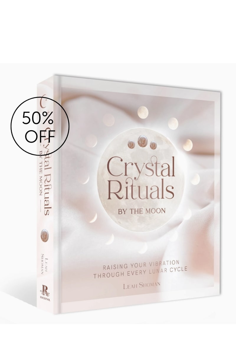 A boxed book titled Crystal Rituals with a 50% off sticker