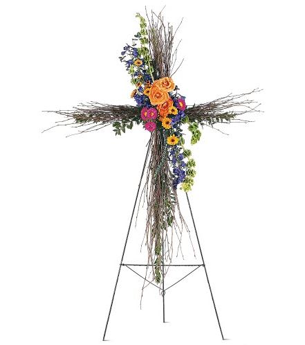 Floral cross on a metal stand with orange, pink, and blue flowers