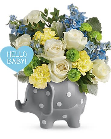 Bouquet of white roses, yellow carnations, and blue flowers in a gray elephant planter with a "Hello Baby" sign.