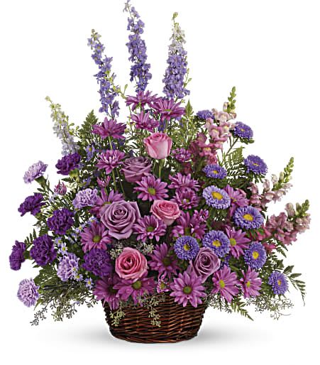 Gracious Lavender Basket - Soothing lavender, respectful purple and compassionate pinks are combined beautifully in this basket overflowing with pretty flowers, sincerity and sympathy. A lovely way to share your thoughts and pay tribute to someone special.  A profusion of purple, pink and lavender blooms such as roses, carnations, larkspur, matsumoto and monte cassino asters and much more are delivered in a round wicker basket. Approximately 24 1/2" W x 28" H