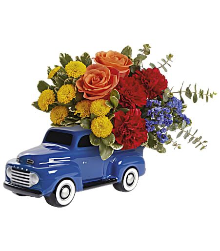 Blue toy truck filled with colorful flowers