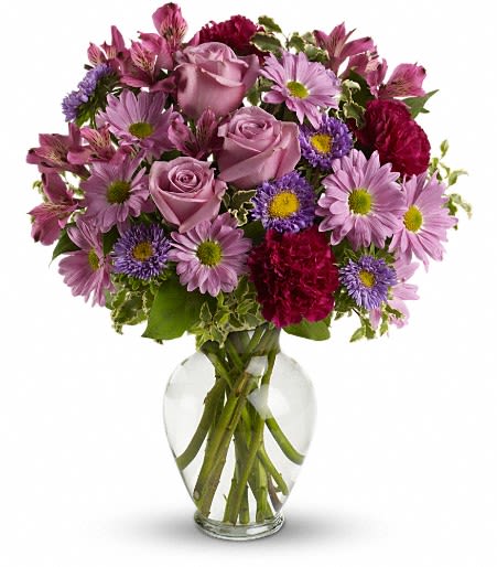 Pink and purple mixed bouquet in a clear glass vase