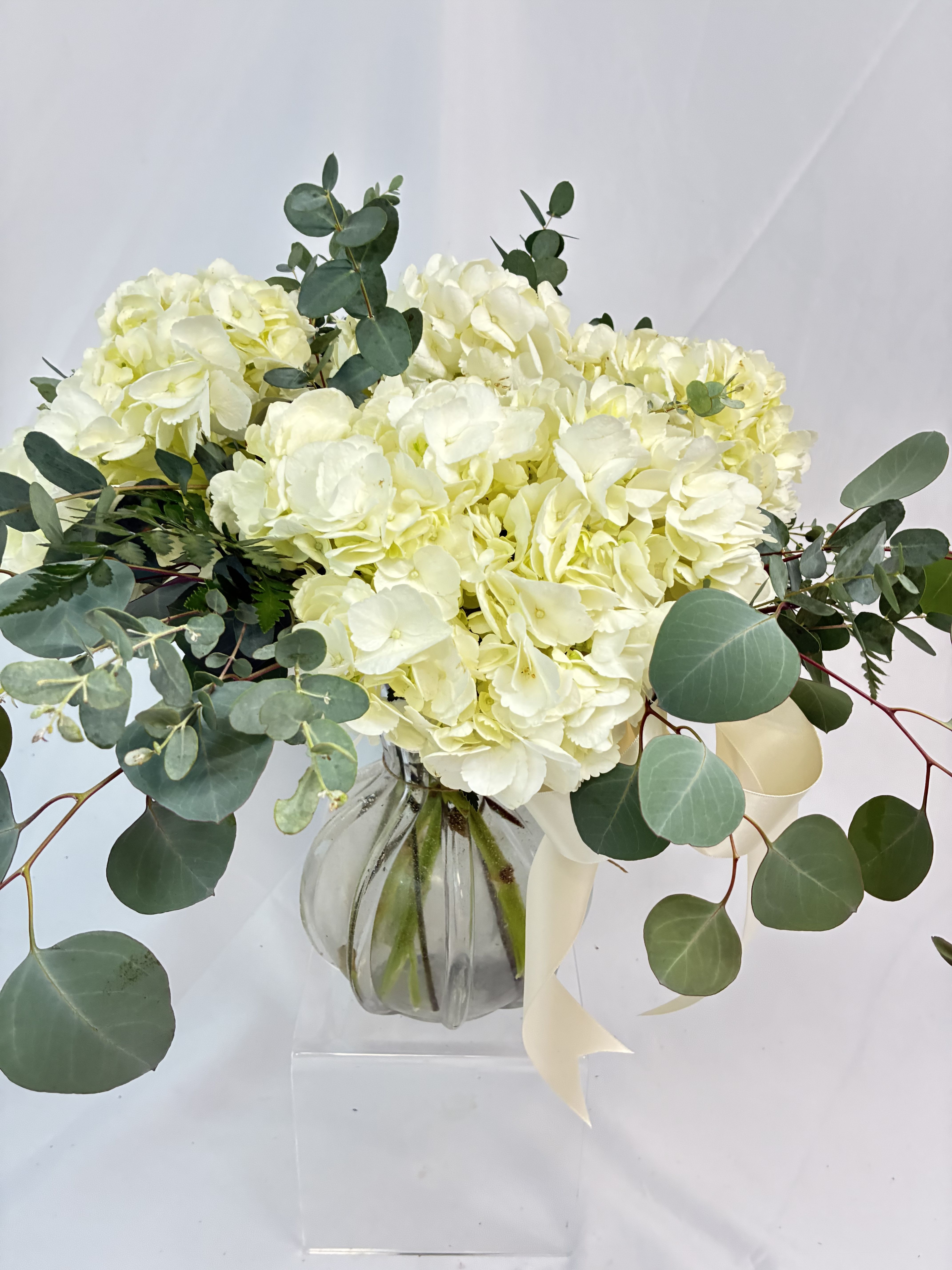 Hydrangeas in Gold Bouquet - Simple elegance with fresh Hydrangeas accented with Eucalyptus is represented! Delivered in this Mud Pie glass vase accented with gold to use over &amp; over! 