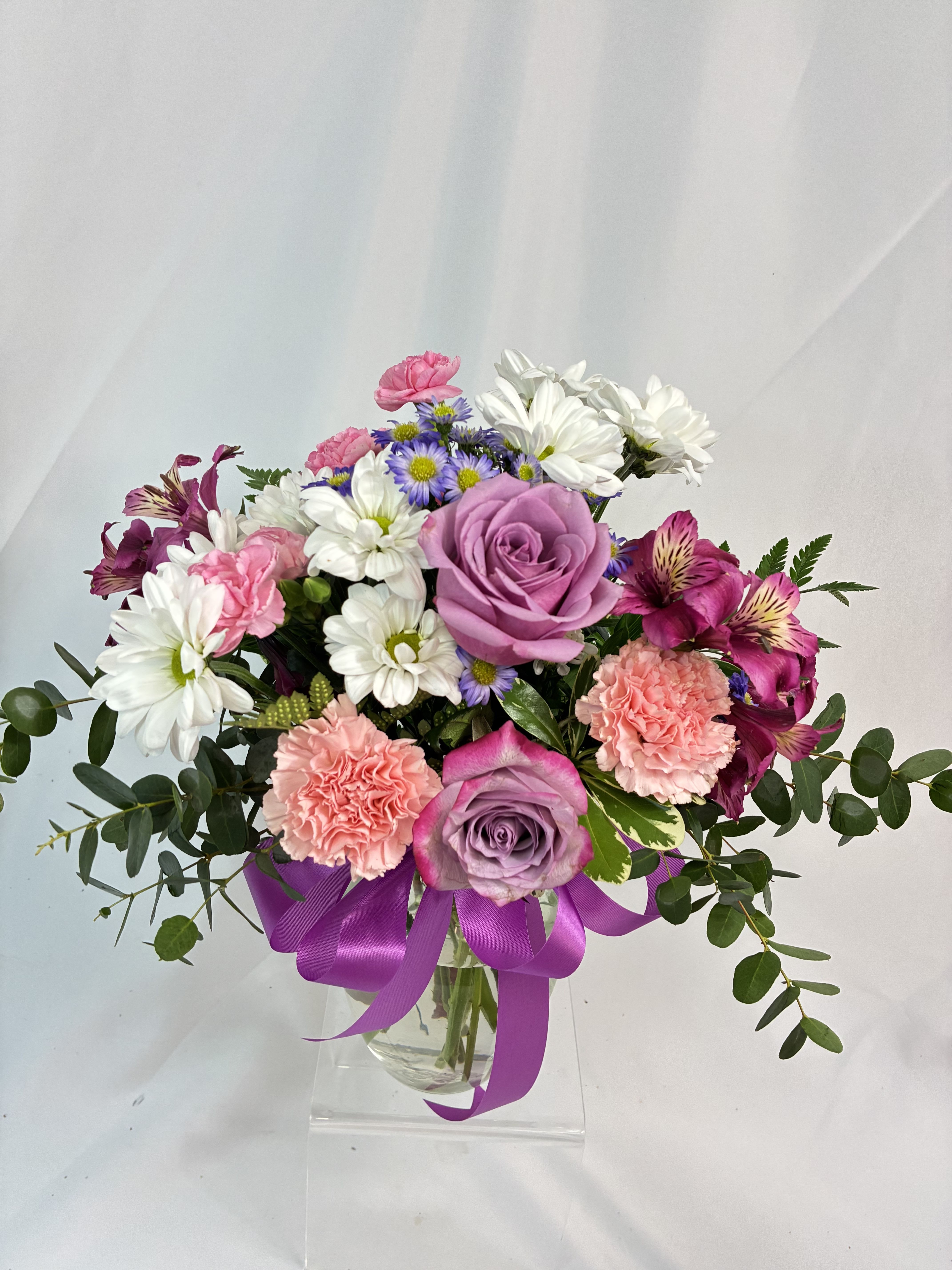 Purple Love Bouquet - Purple Roses are the star of this bouquet! Co-starring are Daisies, Chrysanthemums &amp; Lilies with Eucalyptus accents! Purple lovers are sure to enjoy the show of this bouquet! 