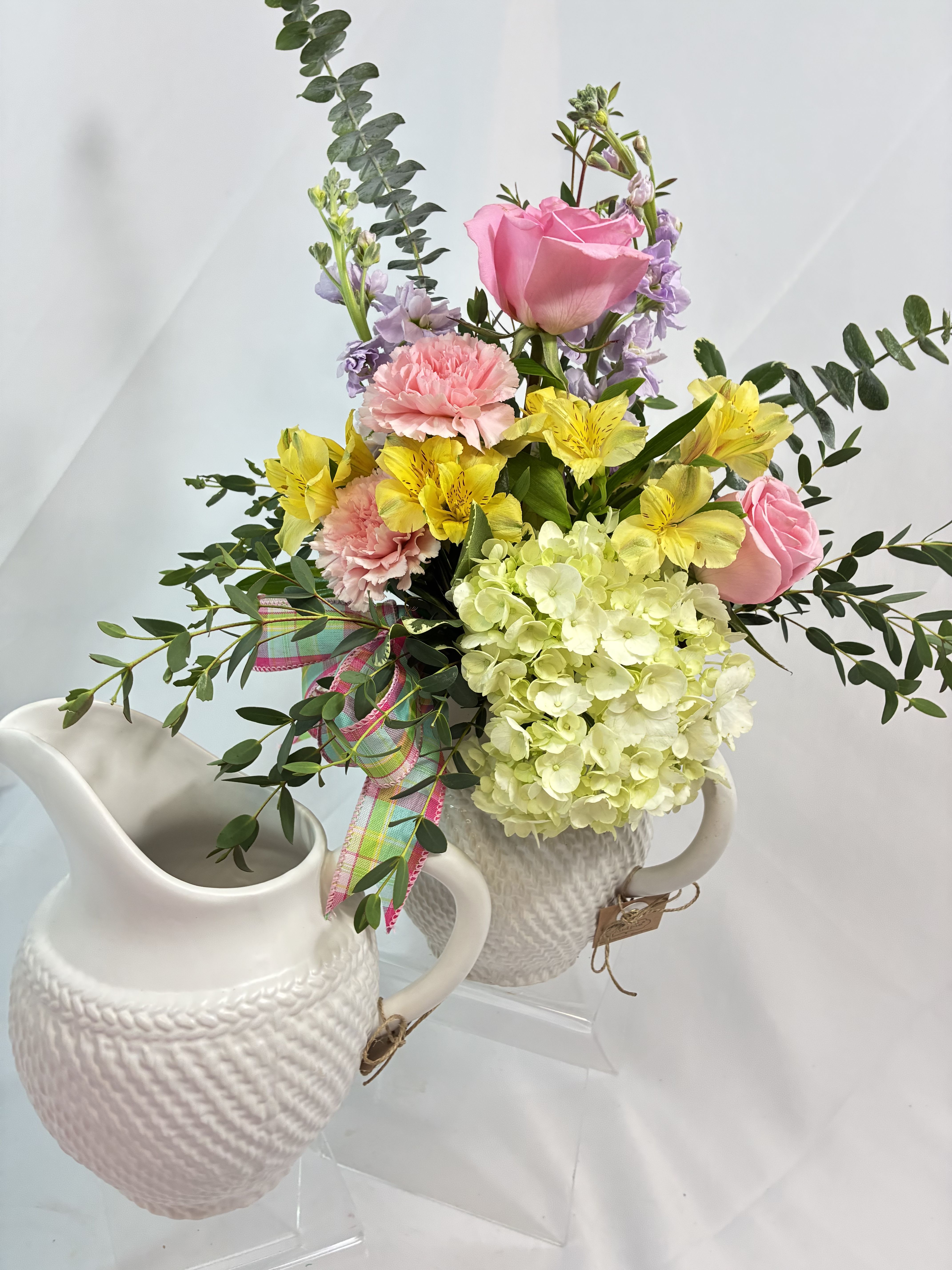 Pitcher of Spring - What a gift that lasts! This Spring bouquet comes in a Mud Pie brand ceramic pitcher to use and keep. Colorful Spring colors of Roses, Alstroemeria, Chrysanthemums mix with Eucalyptus accents. A present for now and later is sure to make them happy! The upgrade options will include more premium flowers.
