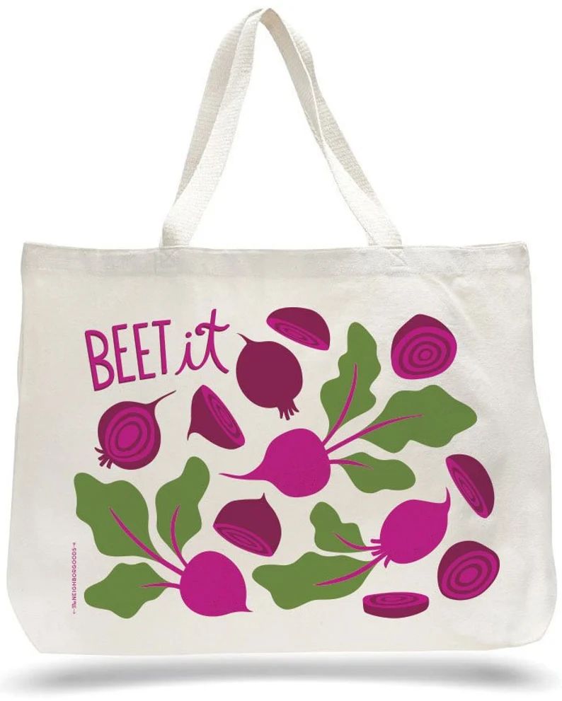 White canvas tote bag with pink beet illustrations, green leaves, and the phrase “BEET it” in pink lettering